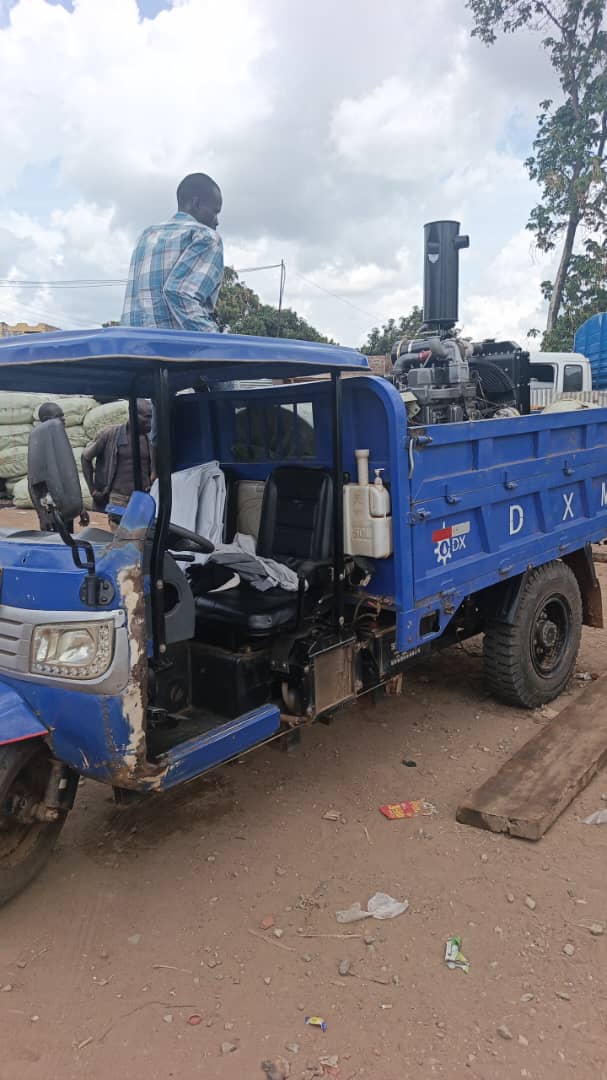 Blue cargo tricycle loaded with the engine, side view