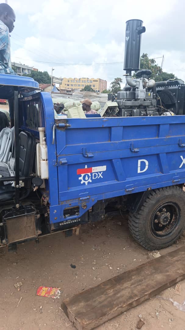 Blue DX cargo tricycle loaded with the engine, driver-side view