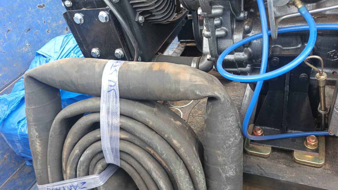 Pump head and coiled rubber hoses